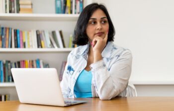 Worried Hispanic woman  with laptop